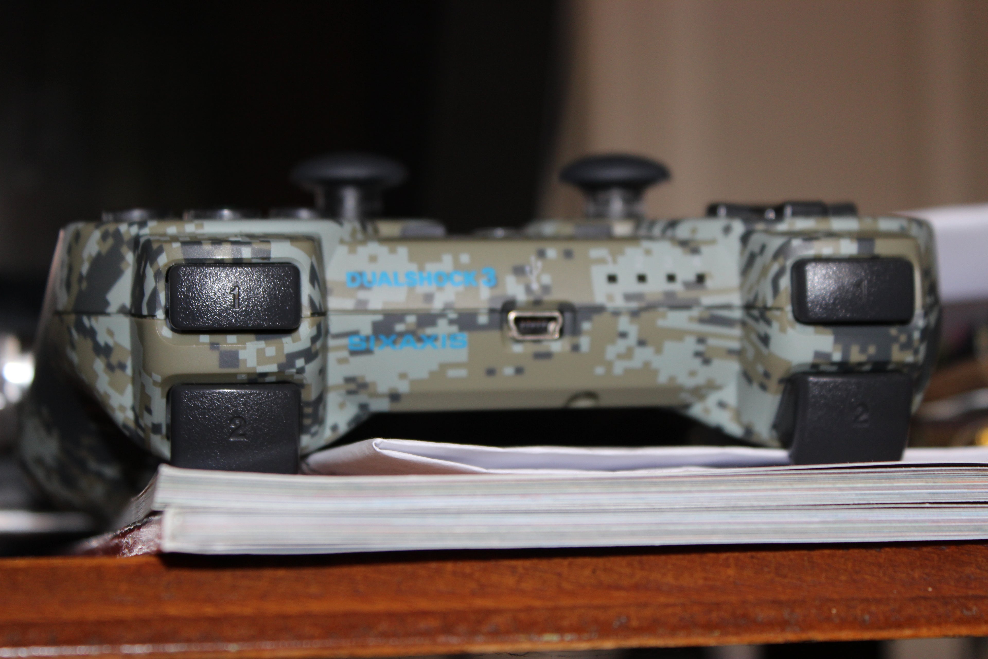 A playstation controller on a table